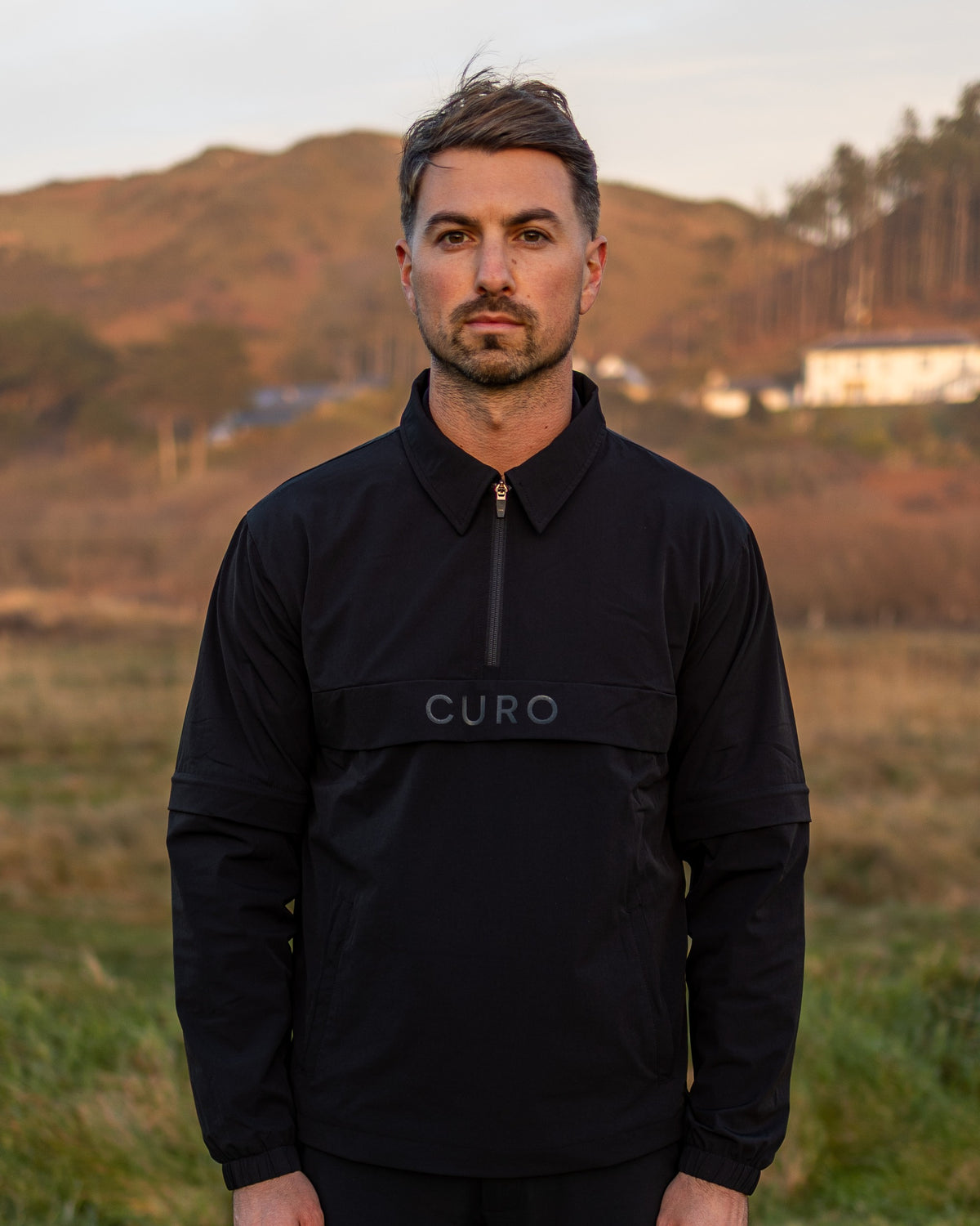 Cadence Windshirt in black, worn on the course