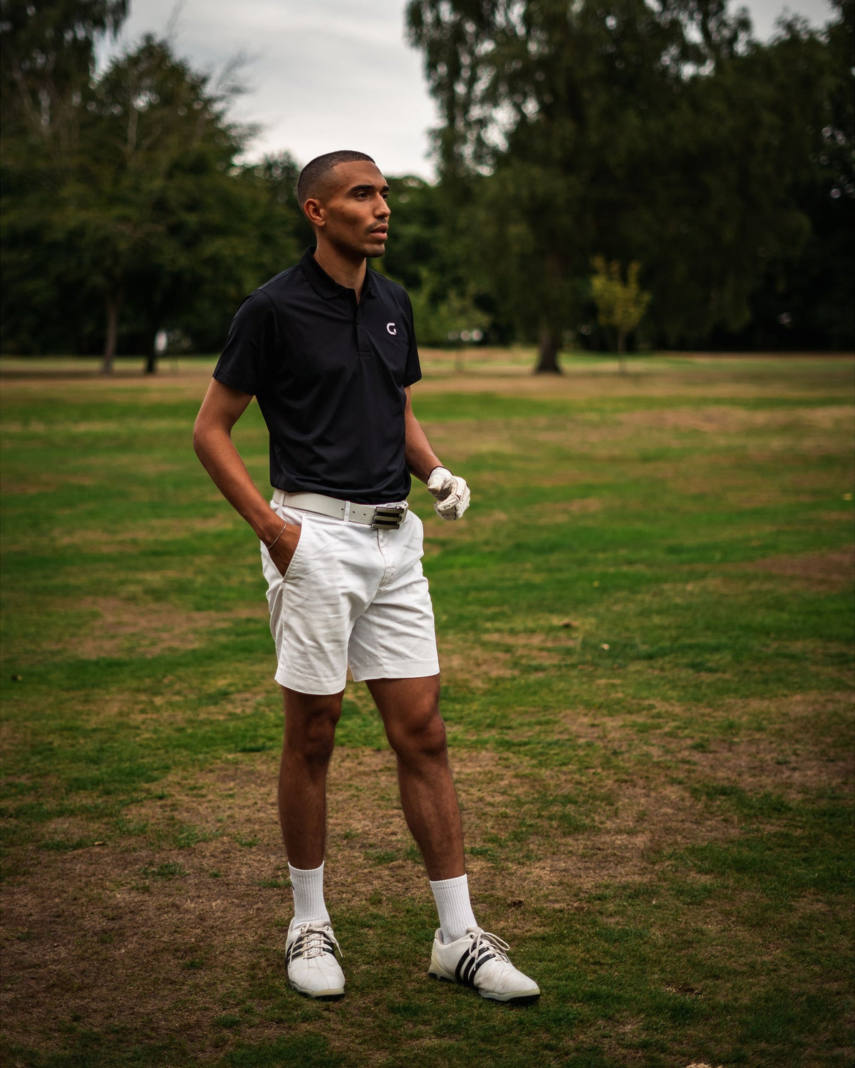 Block Polo Shirt in black, worn on the course