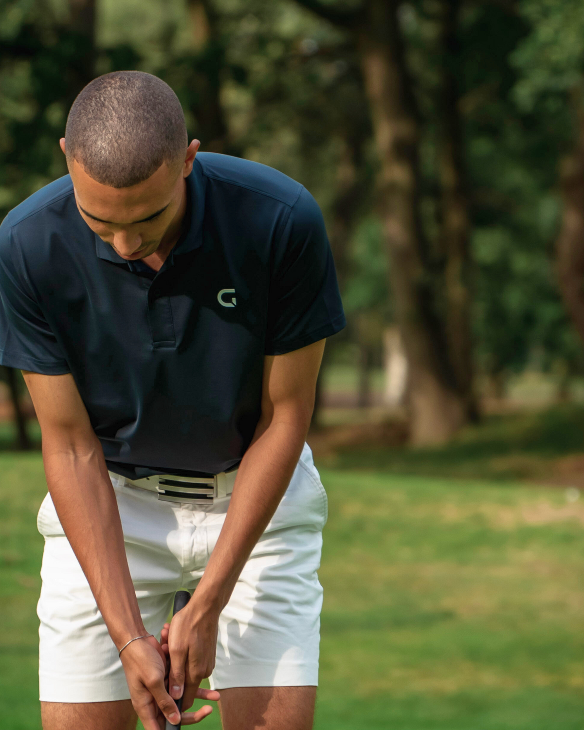 Block Polo Shirt in navy, worn on the course