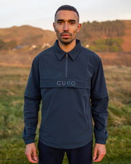 Cadence Windshirt in navy, worn on the course