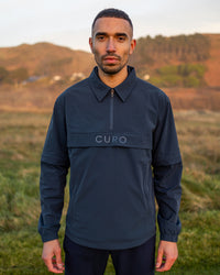 Cadence Windshirt in navy, worn on the course