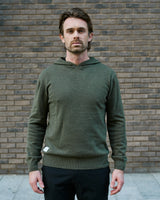 Merino Haven Hoodie in green, worn in the city