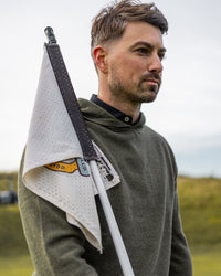 Merino Haven Hoodie in green, worn on the course