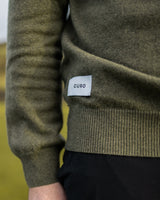 Merino Haven Hoodie knit and hem label detail in green
