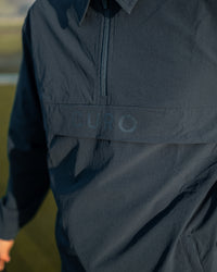 Cadence Windshirt chest branding detail in navy