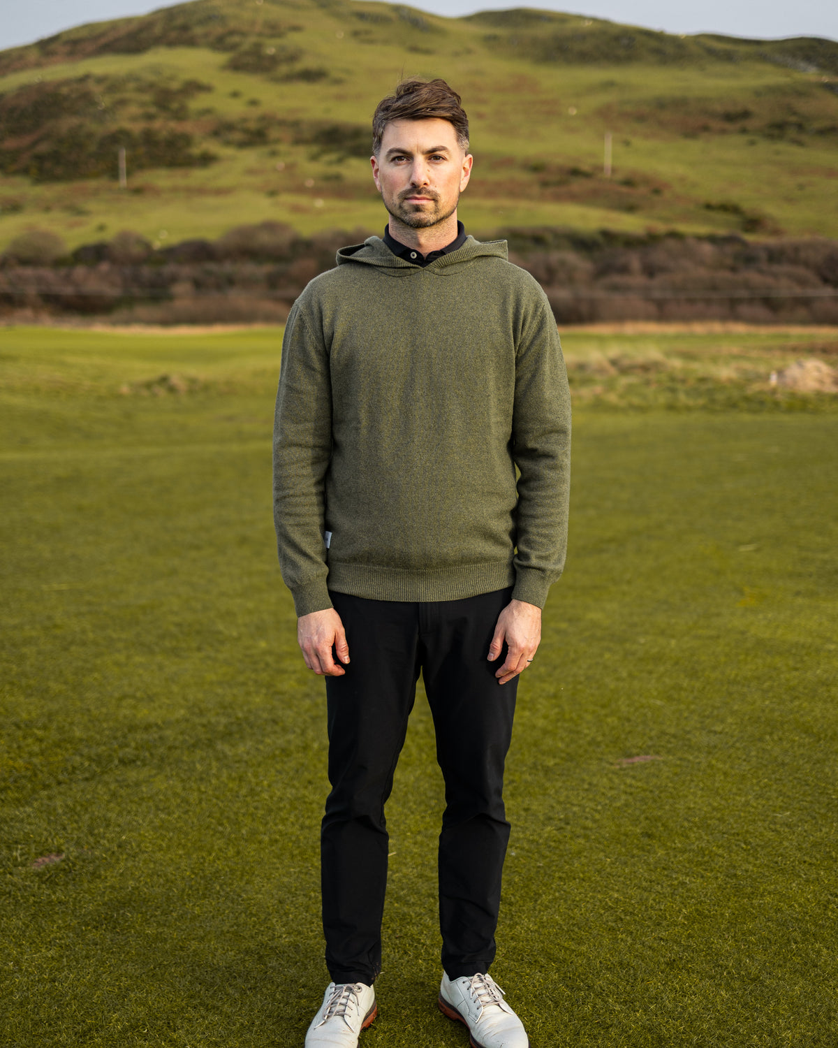 Merino Haven Hoodie in green, full length on the course