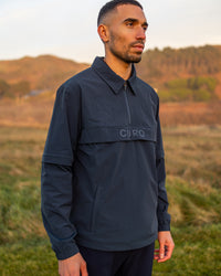 Cadence Windshirt in navy, worn on the course