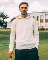 Merino Haven Hoodie in cream, worn at the golf club