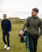 Merino Haven Hoodies in green and navy, walking off the course