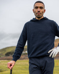 Merino Haven Hoodie in navy, close-up on the course