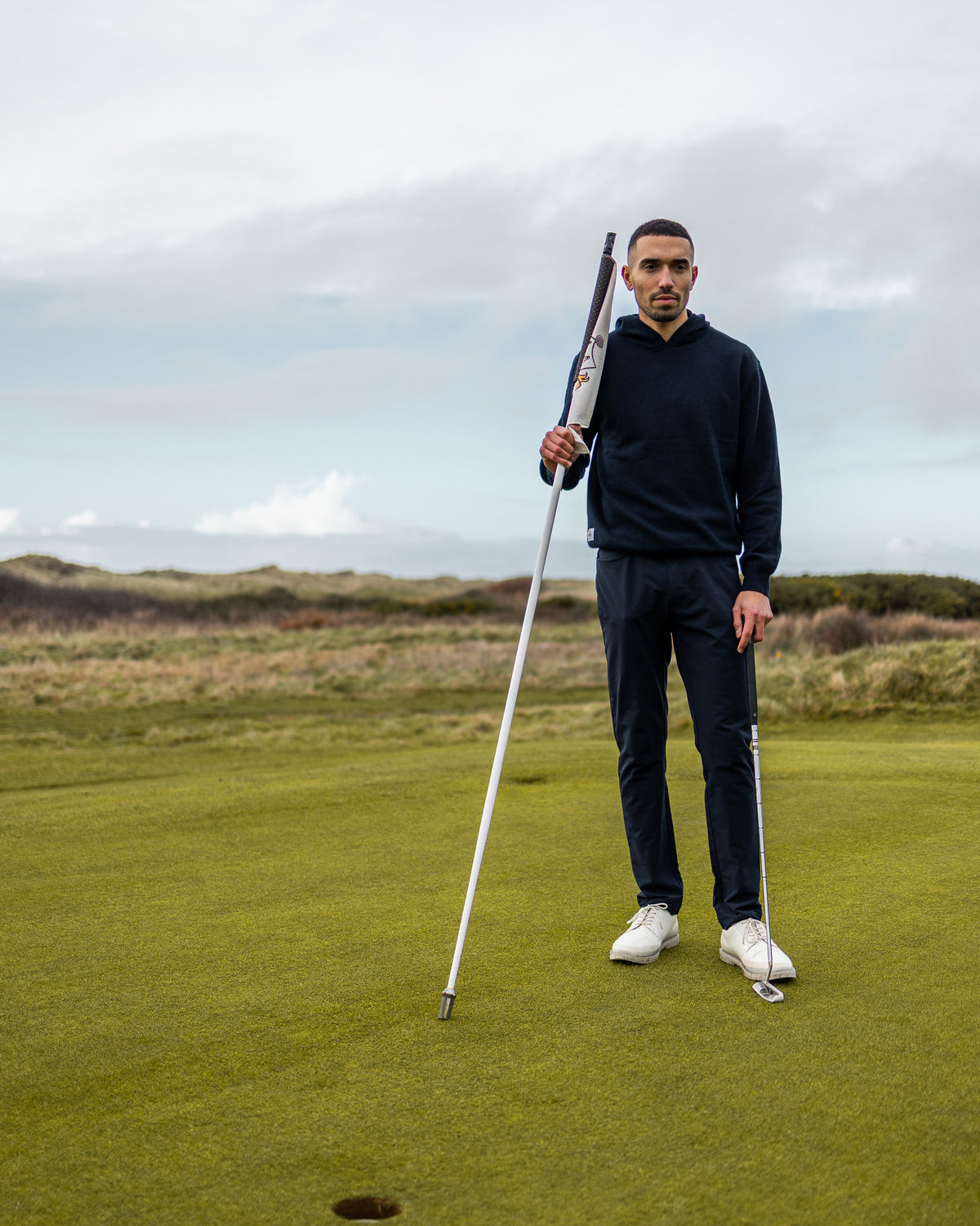 Merino Haven Hoodie in navy, full length on the green