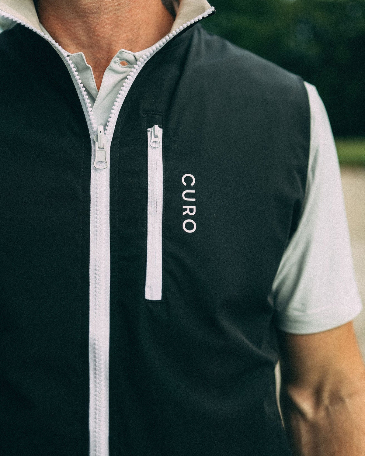 Revere Reversible Gilet in black, chest pocket detail