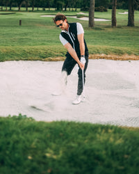 Revere Reversible Gilet in black, playing out of a bunker