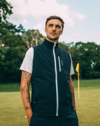 Revere Reversible Gilet in navy, worn on the course